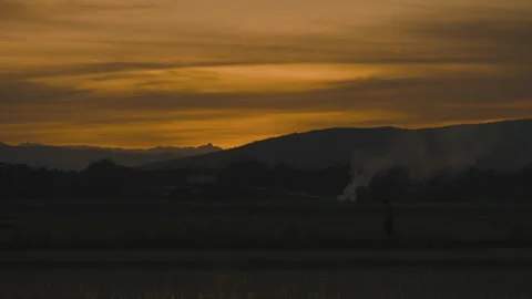 Sunset on golden sky over mountain background Stock Footage 246875348