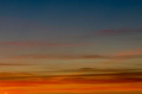 Sunset gradient from blue to orange Stock Photos