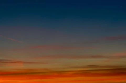 Sunset gradient from blue to orange Stock Photos