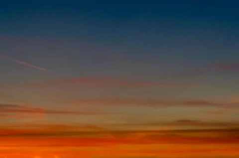 Sunset gradient from blue to orange Stock Photos