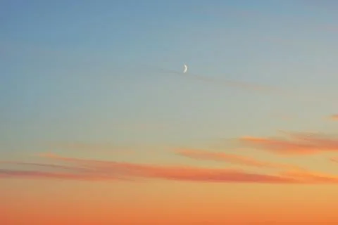 Sunset half moon pink clouds. Stock-Fotos