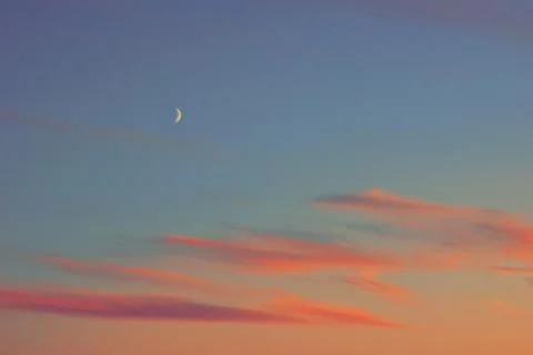 Sunset half moon pink clouds. Stock-Fotos