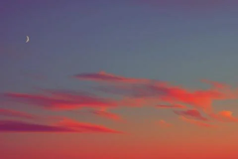 Sunset half moon pink clouds. 스톡 사진