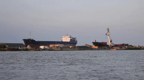 Sunset, harbor, abandoned shipyard, old cracked rusty ships Stock Footage 49680180