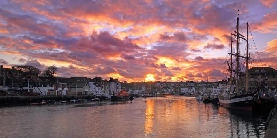 Sunset at the harbour Stock Photos