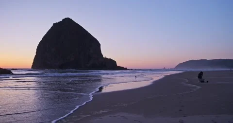 A sunset at Haystack Rock at Cannon Beach in Oregon. 4K. Stock Footage 276989638