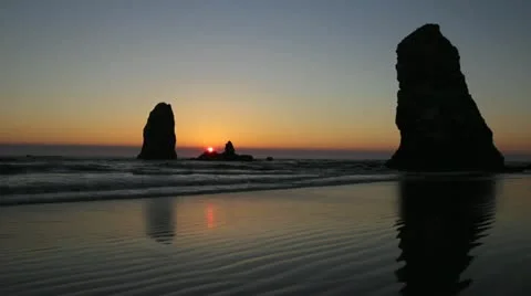 Sunset with Haystack Rocks in Cannon Beach in Oregon at Lowtide 1080p Stock Footage 12109993