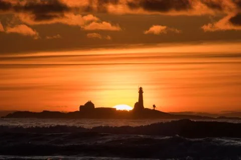 Sunset Hellst beach with lighthouse yellow red Norway Stock Photos