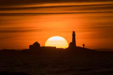 Sunset Hellst beach with lighthouse yellow red Norway Stock Photos