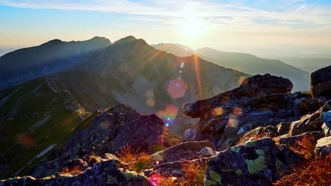 Sunset in high mountains with clouds over them. Видео 269784996