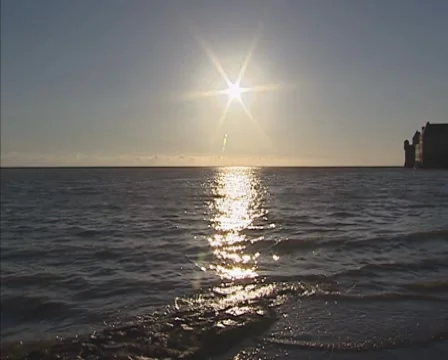 Sunset at high tide + pan Mont Saint-Michel on a rocky islet in tidal bay Stock Footage 45963450