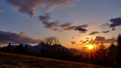 Sunset in a hilly rural landscape on the edge of a forest, Timelapse Stock Footage 268702811