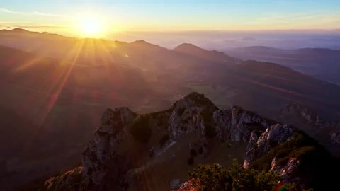 Sunset in a hilly summer landscape, rocks and rhombus illuminated by the setting Stockbeeldmateriaal 265658145