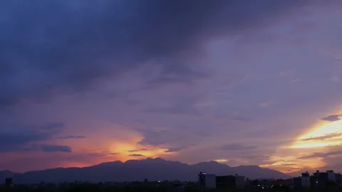 Sunset on the horizon makes the whole sky colorful with soft purple Stock Footage 258636894