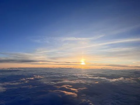 Sunset on the horizon - mid flight Stock Photos