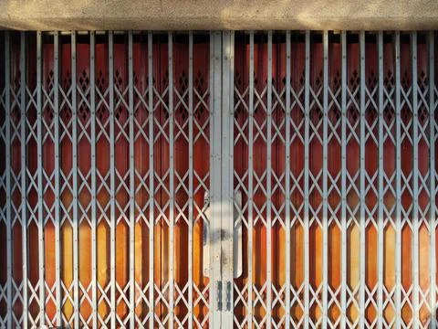 Sunset Hues Behind Security Grille Foto stock