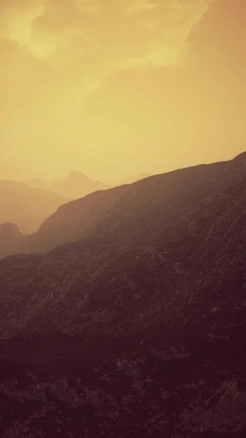 Sunset hues paint the mountains with warm golden shades in serene landscape Stock Footage 335096711