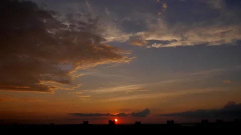 Sunset Hyperlapse. The sun slowly descends behind the buildings of the city Stock Footage 221482199