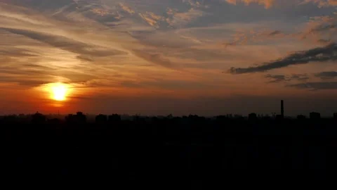 Sunset Hyperlapse. The sun slowly descends behind the buildings of the city Stock Footage 221482271