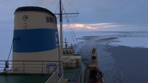 Sunset on the ice floe seen from the deck of boat, North Pole Stock Footage 104875329
