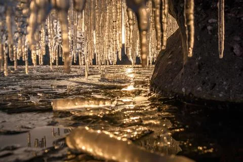 Sunset ice icicles reflection mountains curtain Stock Photos