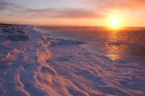 Sunset on the icy seaside Stock Photos