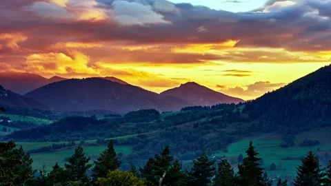 Sunset in an idyllic hilly landscape, beautifully colored clouds, summer rural Stock Footage 294594094