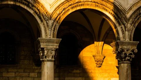Sunset illuminates the facade of an old building. Stock Photos