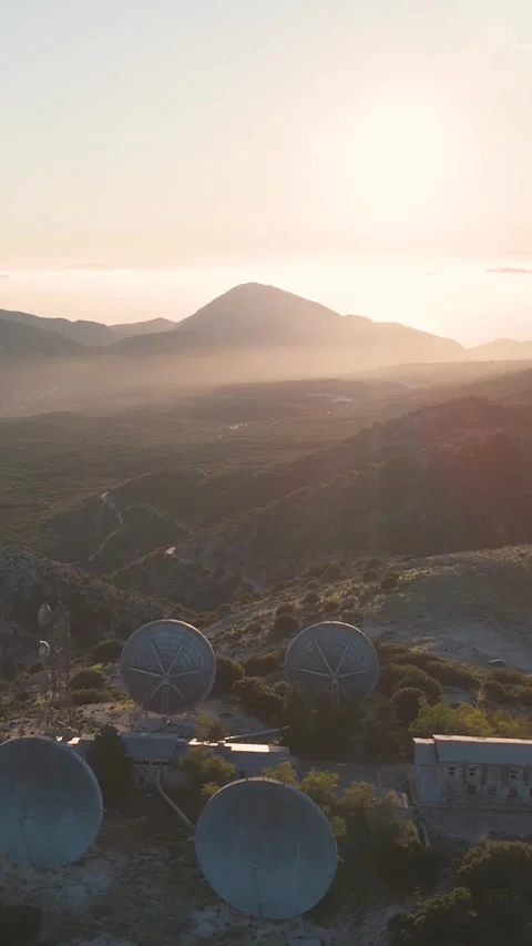 Sunset illuminating satellite dishes on mountaintop Stock Footage 290449633