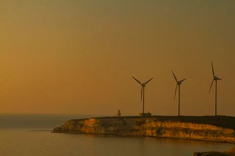 Sunset image of the wind farm located on western cape of Bozcaada, Turkey Stock Photos