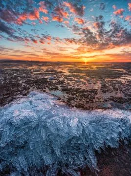 Sunset for an incredibly beautiful sky reflected in the cold ice 写真素材