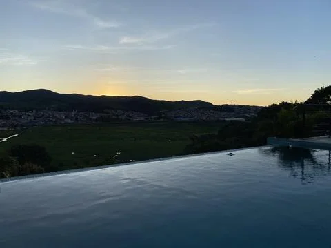 Sunset in an infinity pool. Stock Photos