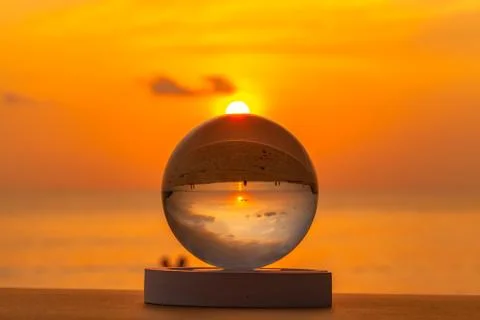 Sunset inside the crystal ball on the beach Stock Photos