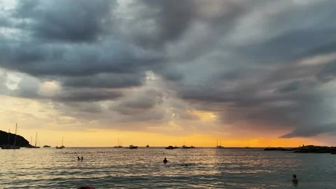 Sunset on the island. Orange sunset can be seen in the cloudy sky. The water Stock Footage 164835588