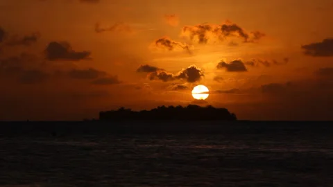 Sunset with island silhouette Stockbeeldmateriaal 160085643