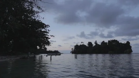 Sunset in a island viewed from the water Stockbeeldmateriaal 109206226