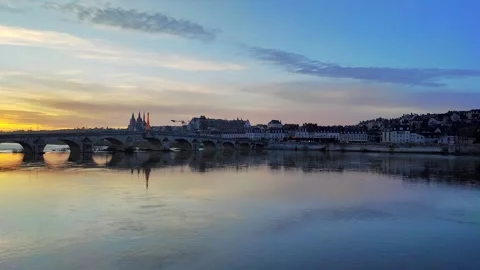 Sunset at the Jacques Gabriel Bridge across the Loire River in Blois, in Fran Stockbeeldmateriaal 332617479