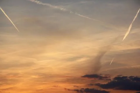 Sunset with Jet Streams in the Sky Stock Photos