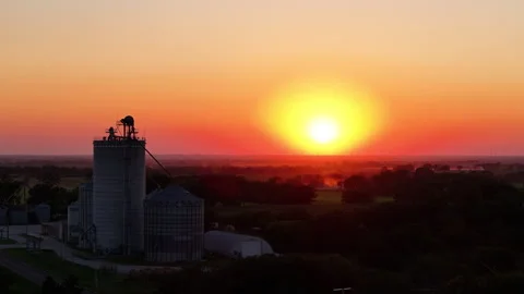 Sunset in Kansas fly by grain silo elevator farm golden hour Stock Footage 297829312
