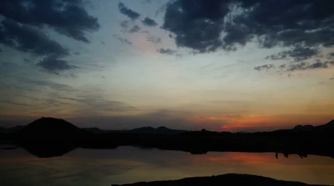 Sunset lake and campfire reflection. Stock Footage 67977903