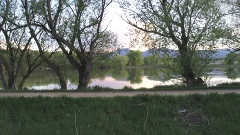 Sunset in lake and mountains - Drone camera moves forward and right Stock Footage 137862022