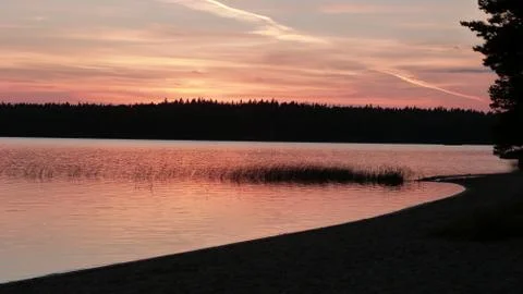 Sunset at lake from beach Stock Photos