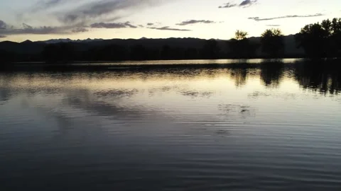 Sunset lake with bird - Drone camera moves right, left, and down Stock Footage 137864729