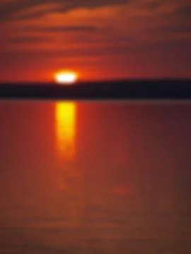 Sunset on the lake with a blurred background Stock Photos