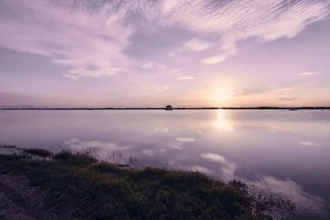 Sunset on the lake, with clouds Stock Photos