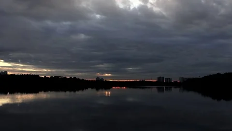 Sunset on the lake in clouds - Timelapse Video stock 70217609