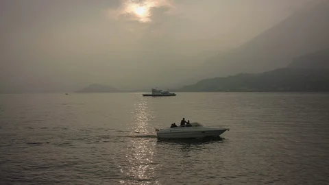 Sunset on Lake Como. Reflection of the sun in the water cross the ship and boat Stock Footage 129069149