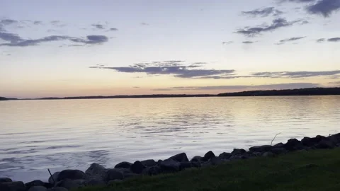 Sunset Lake edge with Rocks 4K HDR Stock Footage 250370817