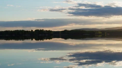 Sunset on the lake with a mirror image of the sky on the water. Stock Footage 276353820