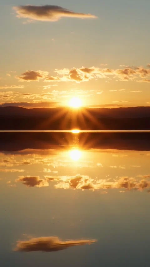 Sunset on the lake with a mirror image of the sky on the water. Stock Footage 276876872